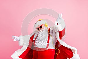 Photo modern funky santa claus listen x-mas christmas stereo radio use headphones raise hands fingers wear style stylish photo