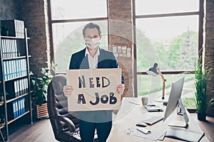 Photo of moody office worker mature guy holding placard poster looking for new job fired bad mood modern office indoors