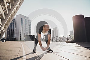 Photo of motivated confident sporty active man stretch hands body exercise cardio warm up urban town outdoors