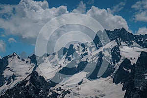 Photo of mountains with snow in summer in dombai