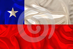 Photo of the national flag of Chile on a luxurious texture of satin, silk with waves, folds and highlights, close-up, copy space,
