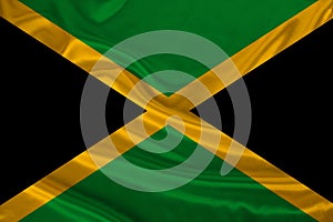 Photo of the national flag of the state of Jamaica on a luxurious texture of satin, silk with waves, folds and highlights, close-