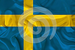 Photo of the national flag of the state of Sweden on a luxurious texture of satin, silk with waves, folds and highlights, close-up