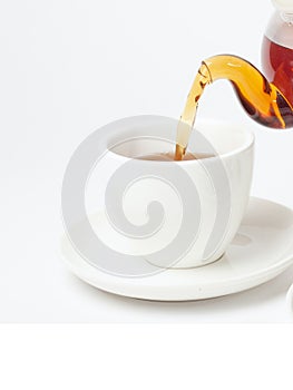 Photo of a natural tea poured into a cup. photo