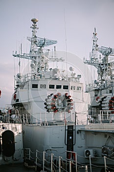 Photo of a naval warship docked at the pier,