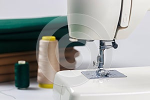 Photo of a needle with thread attached to sewing machine.