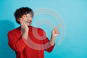 Photo of nervous excited mexican guy in red pullover direct finger mockup copyspace tickets avia sale isolated on blue