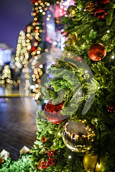 Photo of New Year decorated fir trees on blurred background