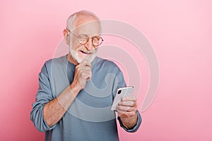 Photo of nice aged grey hairdo man look telephone wear eyewear blue shirt isolated on pink color background