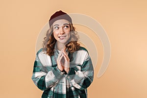 Photo of nice caucasian woman in knit hat thinking and looking aside