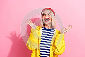 Photo of nice cheerful girl wear yellow striped clothes red hat look up empty space rejoice cool offer isolated on pink