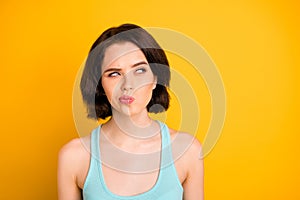 Photo of nice cute cunning sly girl serious pondering over something while isolated with yellow background