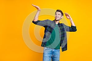 Photo of nice guy crazy dancer inviting friends to dance floor wear casual plaid shirt isolated yellow color background