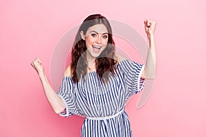 Photo of nice hooray brunette lady hands fists wear blue dress isolated on pastel pink color background