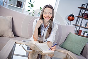 Photo of nice optimistic brunette lady sit with headphones write lookn wear shirt alone at home