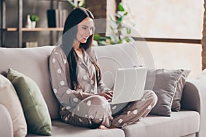 Photo of nice optimistic girl sit with laptop wear pijama at home photo
