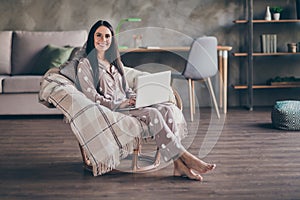 Photo of nice optimistic girl sit type laptop wear pijama spectacles at home photo