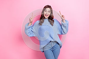 Photo of nice positive girl toothy smile arms fingers show v-sign isolated on pink color background
