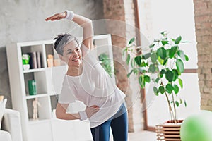 Photo of nice retired woman warm up exercises sportswear sport healthy lifestyle workout modern apartment home living