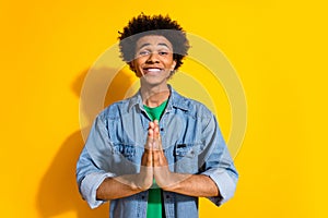 Photo of nice young man arms plead empty space wear denim shirt isolated on yellow color background photo