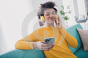 Photo of nice young man headphones phone closed eyes wear yellow pullover white interior apartment indoors