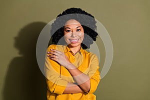 Photo of nice young woman hand touch shoulder wear yellow shirt isolated on khaki color background