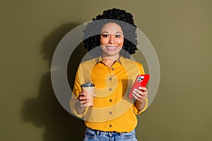 Photo of nice young woman smart phone coffee wear yellow shirt isolated on khaki color background