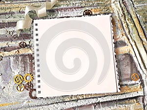 Photo of notepad against the background of a relief wall with decorative elements