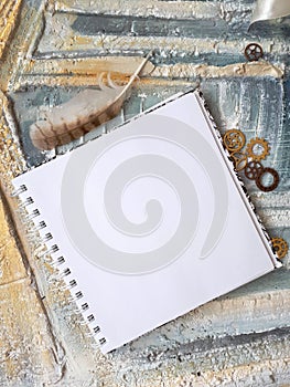 Photo of notepad against the background of a relief wall with decorative elements