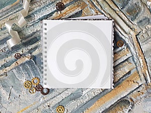 Photo of notepad against the background of a relief wall with decorative elements photo