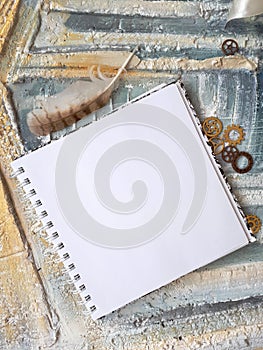 Photo of notepad against the background of a relief wall with decorative elements photo
