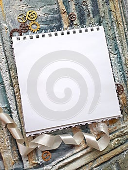 Photo of notepad against the background of a relief wall with decorative elements photo