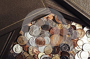 Photo of old antique books laying on coins