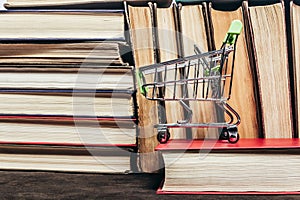 Photo of old antique books stack and row with cart