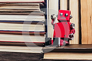 Photo of old antique books stack and row with robot