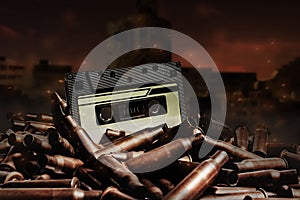 Photo of an old audio tape cassette on pile of bullets