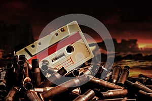 Photo of an old audio tape cassette on pile of bullets