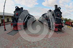 Photo of old black steam locomotives of the Soviet Union. Strong distortion from the fisheye len