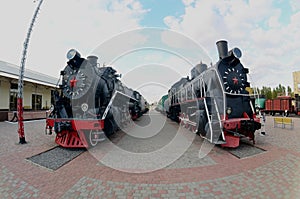 Photo of old black steam locomotives of the Soviet Union. Strong distortion from the fisheye len