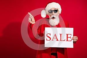 Photo of old grey haired retired pensioner man point finger empty space sale card xmas isolated on red color background