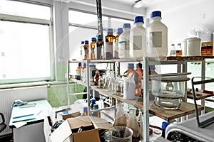 Photo of an old laboratory with a lot of bottles