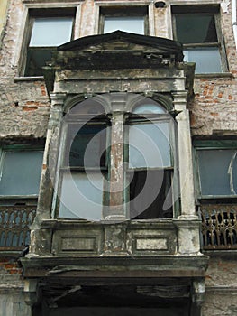 Old ruined terrace with two broken windows