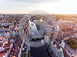 Photo of the old town of Gdansk architecture in sunset light. Aerial shot. Channel and buildings - top view