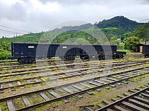 Photo of old train and wailroad cars on the old railway station at mountains of Sri Lanka