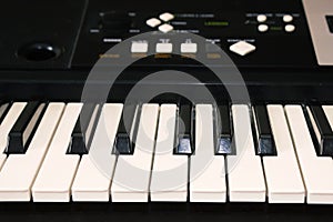 A photo of old used synthesizer, electronic musical keyboard. Keyboard or piano for digital music recording, a music instrument ba