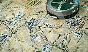 Photo of old vintage map on aged page with compass, retro