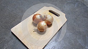 Photo of Onions On A Wooden Tray with Close Diagonal Angle.