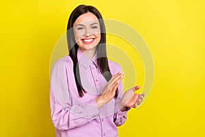 Photo of optimistic brown hairdo millennial lady clap hands wear purple shirt isolated on yellow color background