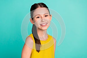 Photo of optimistic nice brown hair girl wear yellow dress isolated on bright teal color background