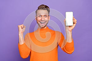 Photo of overjoyed man excited to present you new modern technology website design isolated on violet color background